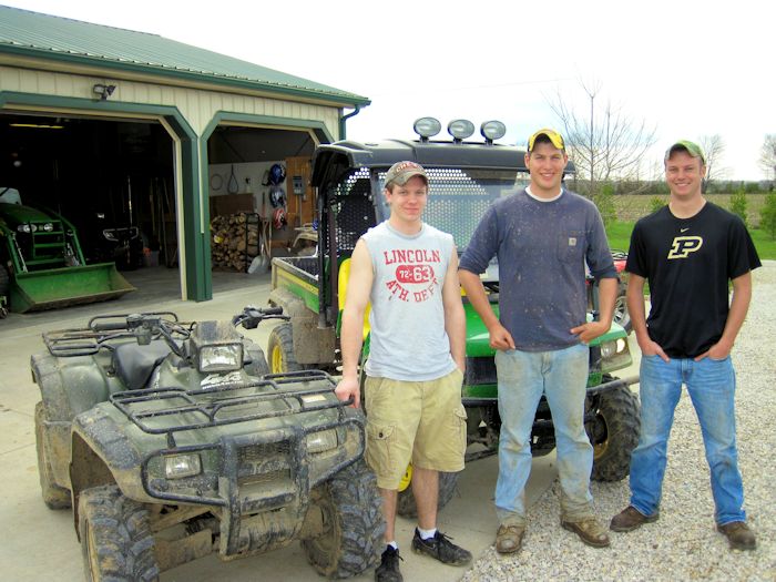 Schmitt, Main, and Schneider posing in front of their chase vehicles