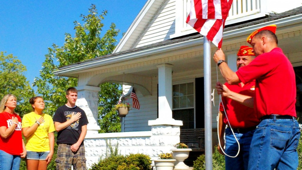 Indiana Commandant Dave Englert and Jasper Vice Commandant Pat Moriarty of the Marine Corps League presented Sandy Terwiske with a flag.