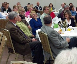 Connie (green) and Alan Nass sat with the Lt. Governor at the Huntingburg Chamber of Commerce Annual Luncheon. They were completely surprised when they learned they had won the Annual Golden Leaf Award.