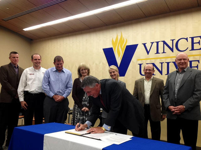 Dick Helton, president of Vincennes University, was the first to sign a new memorandum of agreement