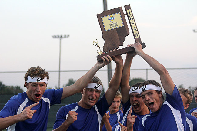 (From left) Northeast Dubois' Tyler Haas, left, Ethan Kieffner, Gage Knies and Bill Schepers hold the school's first tennis sectional champion trophy after winning their match against Barr-Reeve during the boys tennis sectional final at Loogootee High School on Thursday. This is the Jeeps' first sectional championship in program history. 