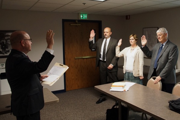 Daviess Superior Court Judge Dean Sobecki swore in the recount committee today in the Pfaffenwieler Room of Jasper's City Hall. From left: Merrill Osterman represents the Republican Party, Jefferson County Clerk Karen Mannix (R) is the voting mechanic and Art Nordhoff Jr. represents the Democrat Party.