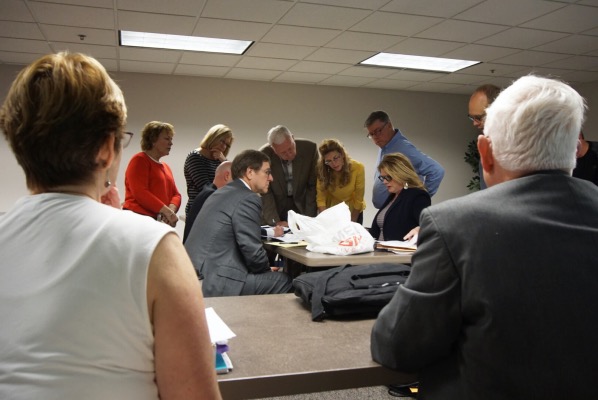 Recount commission members Karen Mannix and Art Nordhoff Jr. observe the six appointed counters go over the process for the recount. From left: Donna Schroeder (Democrat counter), Janet Sendelweck (Democrat counter), counter Jason Schmitt (Democrat counter), Attorney William Groth representing Wayne Schuetter, John Schneider (Republican counter), Melissa Osterman (Republican counter, Stan Jochum (Republican counter), and attorney Samantha DeWester representing Mayor Terry Seitz.