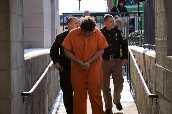 Kyle Popplewell was escorted into the Dubois County Courthouse by Deputy Wade Pierce (left) and Courthouse Security Officer Mike Shaw for his arraignment for the murder of Jeffrey Perry. Popplewell as also charged with two counts of rape, counts of criminal confinement, burglary, intimidation, and battery resulting in serious bodily injury.