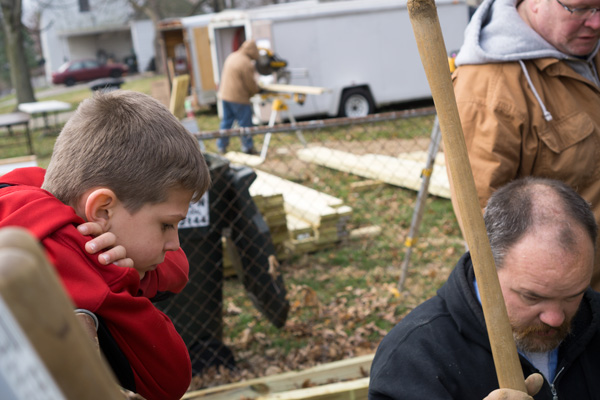 Violet Thyen's grandson Blayton Durcholz, 9, watched Habitat for Humanity volunteer Jeremy Foxen work on the post for the new ramp at Thyen's Willams Street home.