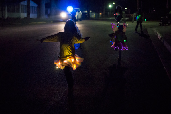 Norah Desser, 6, of Jasper, and Mya Uebelhor, 6, of Jasper, run down 1st Street in Huntingburg for the 5K portion of the Glow in the Park fun run.