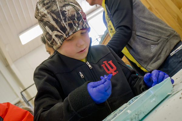 Cole Leinenbach, 8, of Mrs. Pieper's class, made sure he had a seed in his gloved-hand before pushing it into the soil.
