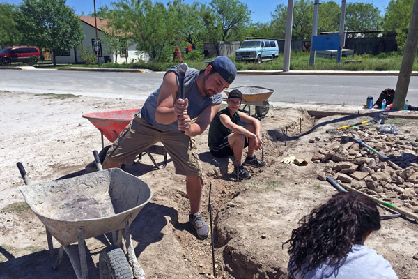 Corey Andry, Christian Church of Jasper youth minister, drove rebar into the ground for the curb project while Nolan Harmon took a break.