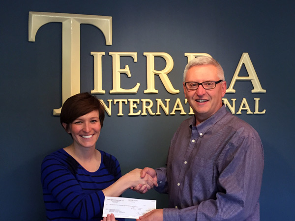 Megan Gatwood accepting the donation from TDI Brands General Manager Mike Bartley.