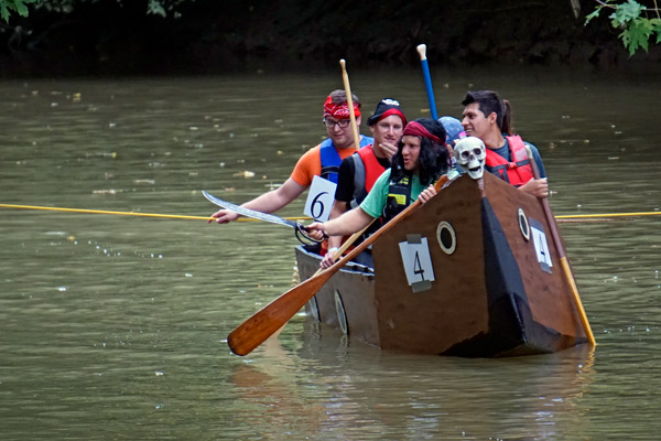 The Stens Corporation team playfully challenged another team before the first heat of the Holy Trinity Cardboard Boat Regatta held on the Patoka River Saturday.