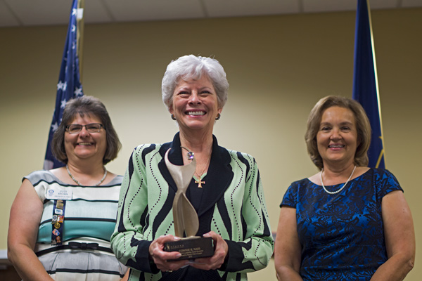 Rotary Club board member Judi Brown and 2015's Athena designee Nancy Eckerle joined in presenting Nass with the 2016 Athena.