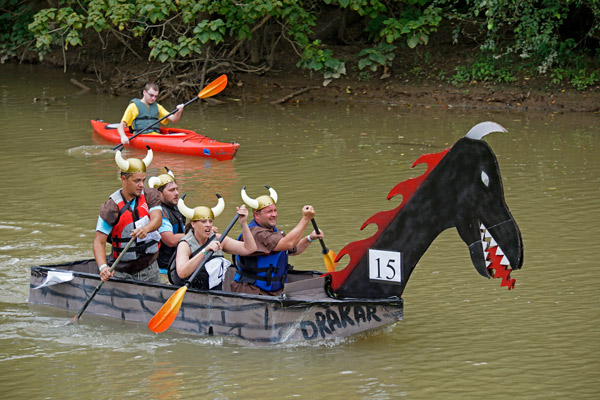 The Jasper Jaycees, right, raced away from the Knights of Columbus during the annual Holy Trinity Cardboard Boat Regatta in the Patoka River at the Dave Buehler Plaza in Jasper on Saturday. 