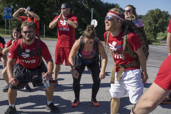 Eric Evitts (right) shouted words of support while the group performed squats. In all they performed 99 squats during the walk.