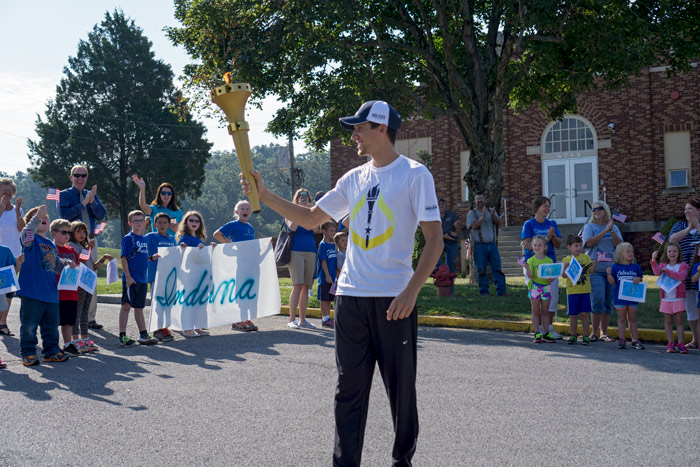 Dustin Betz displayed the torch in front of the Celestine Elementary School before running down the hill to finish the relay. The torch has a camera in the crown that can be activated on with a button near the torch bearer's hand so they can take torch selfies.