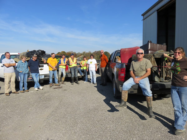  Volunteers pose with pick ups full of some of the 3000 pounds of junk picked up in or near 4 Dubois County waterways during Saturday's Creek Sweep