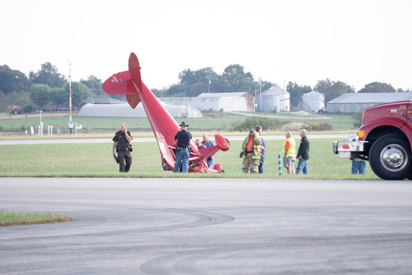 The airplane was positioned in the grass adjacent to runway 27 about 150 yards northeast of the terminal building.