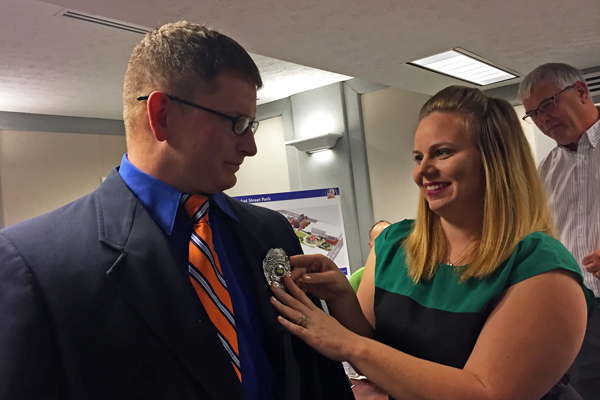Jordan Jones pinned the Huntingburg Police Department badge on her husband during the swearing in ceremony. 