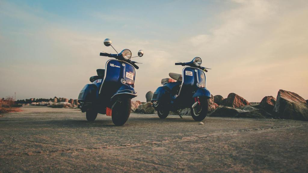 blue mopeds parked on empty road in countryside
